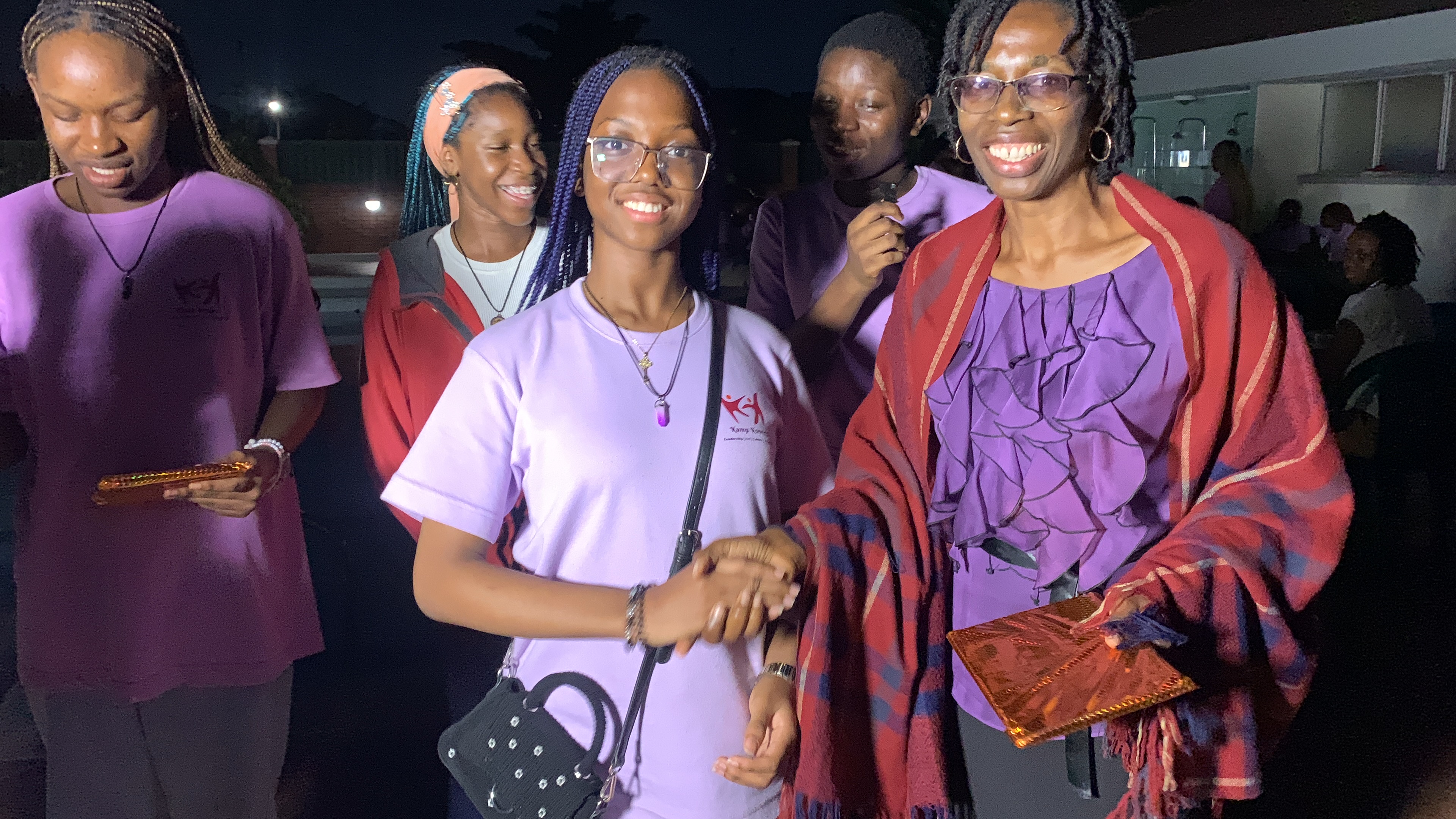 Kamp Konnect participants and mentors smiling together at an evening event